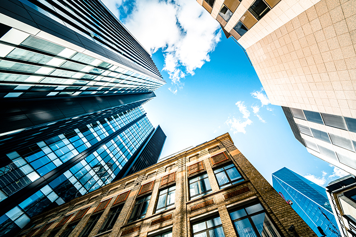 Commercial real-estate buildings, views from a city street.